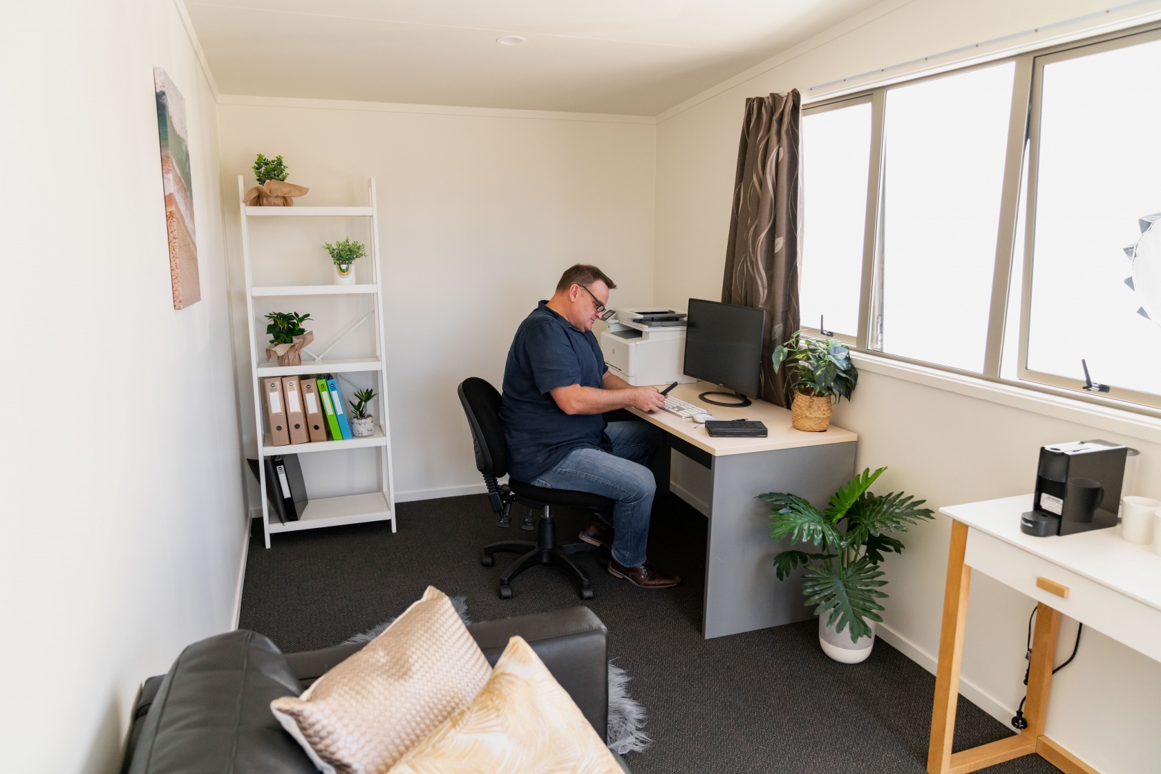 At work in his own office inside a just cabin